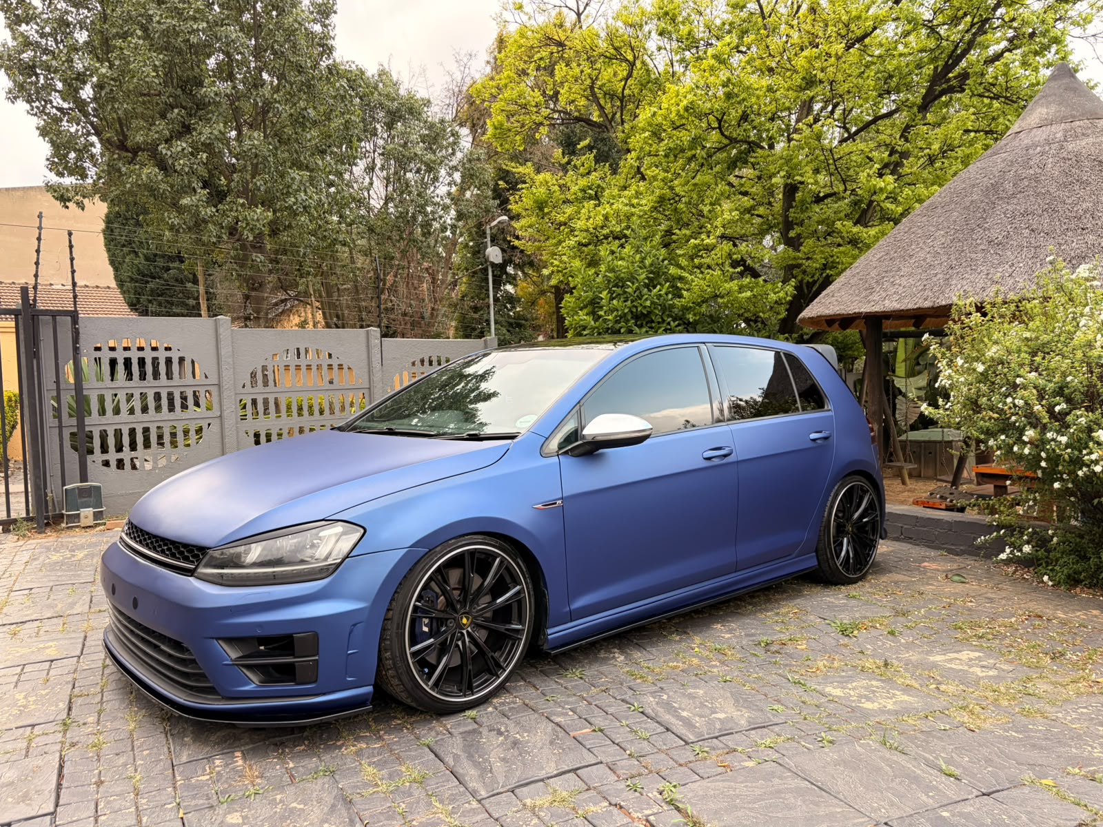 Matte blue Volkswagen Golf R on gloss black multi-spoke wheels