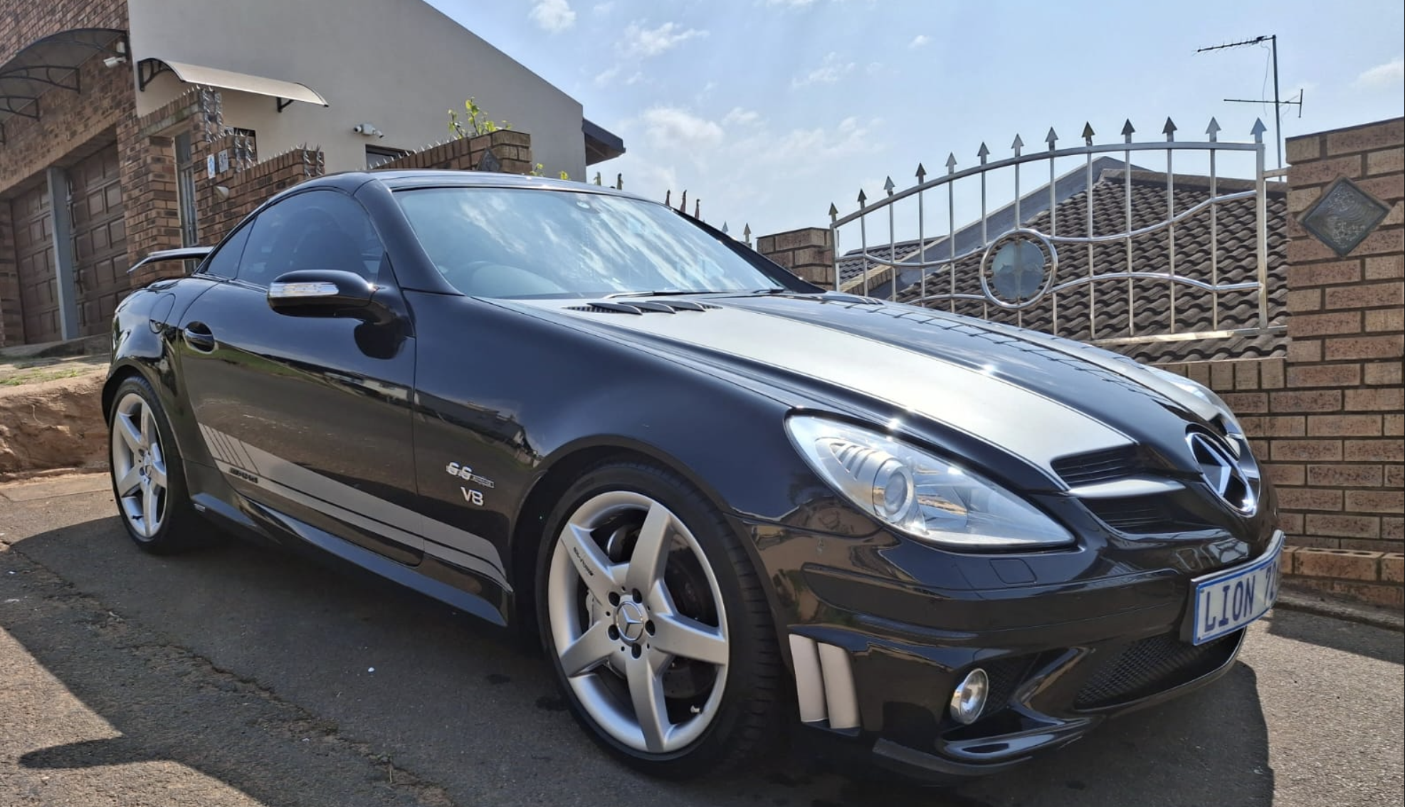 Customer's black Mercedes SLK55 AMG with silver racing stripes after a wash at Gloss n Grip